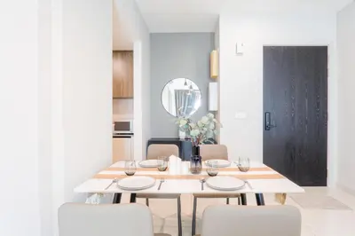 a dining room with a white table and chairs at Datum Jelatek Residence by Airhost in Kuala Lumpur