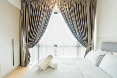 a bedroom with a white bed with a large window at Datum Jelatek Residence by Airhost in Kuala Lumpur
