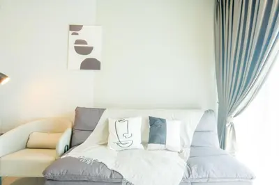 a couch with pillows on it in a living room at Datum Jelatek Residence by Airhost in Kuala Lumpur