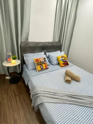 a bedroom with a bed with pillows and a table at SuperMCozy@Setapak Central Mall 10Pax 3BR 2CarPark in Kuala Lumpur