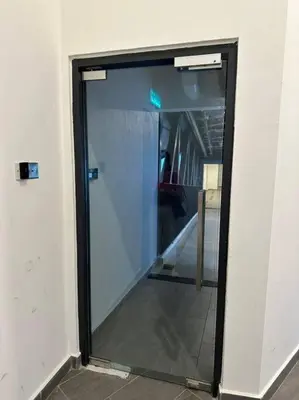 a glass door in a room with a hallway at M Vertica KL City 3B2B 8 Pax [Wi-Fi, 2 Carparks] in Kuala Lumpur