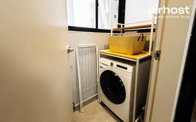 a laundry room with a washing machine and a basket at Trion @ KL by Airhost in Kuala Lumpur