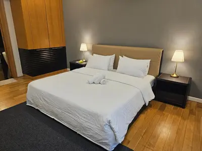 a bedroom with a large bed with white sheets and pillows at Cosy Apartment at St Mary KL City Centre in Kuala Lumpur