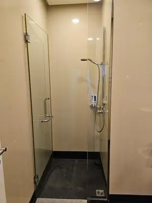 a bathroom with a shower with a glass door at Cosy Apartment at St Mary KL City Centre in Kuala Lumpur