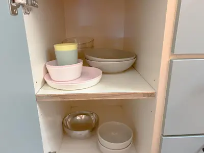 a pantry with bowls and plates on a shelf at VintageHome Lalaport Casa Mutiara Bukit Bintang by Scape Stay in Kuala Lumpur