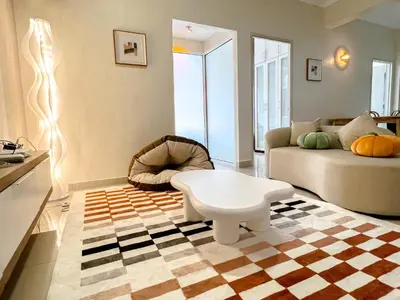 a living room with a couch and a coffee table at VintageHome Lalaport Casa Mutiara Bukit Bintang by Scape Stay in Kuala Lumpur