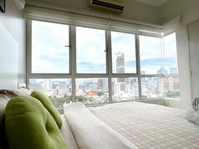 a bed in a room with a large window at VintageHome Lalaport Casa Mutiara Bukit Bintang by Scape Stay in Kuala Lumpur