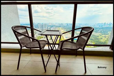 two chairs and a table in front of a window at Skystays360 KL, 60th floor - close to KLCC TRX 2-bedroom 2 bathrooms in Kuala Lumpur