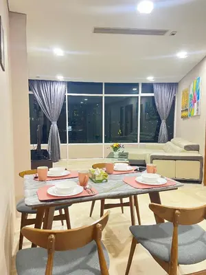 a dining room with a table and chairs and a couch at Vortex Suites KLCC 10 Pax -3 Bedroom Apartment in Kuala Lumpur