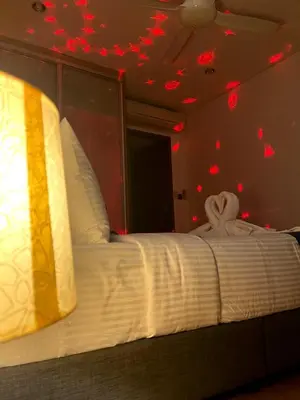 a bedroom with a bed with red lights on the ceiling at Vortex Suites KLCC 10 Pax -3 Bedroom Apartment in Kuala Lumpur