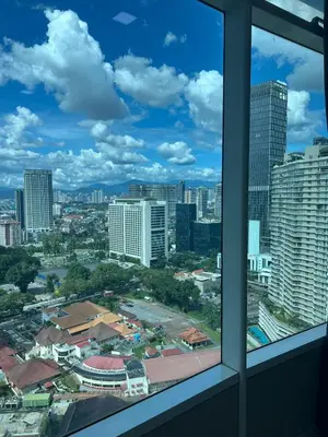 a view of a city from a window at Vortex Suites KLCC 10 Pax -3 Bedroom Apartment in Kuala Lumpur