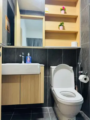 a bathroom with a white toilet and a sink at The Luxe Suites Infinitum KLCC in Kuala Lumpur