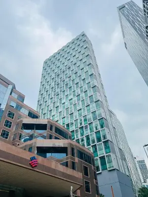 a tall glass building in the middle of a city at Soho Star Suites near by Klcc in Kuala Lumpur
