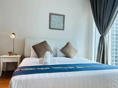 a bedroom with a large white bed with a window at Soho Star Suites near by Klcc in Kuala Lumpur