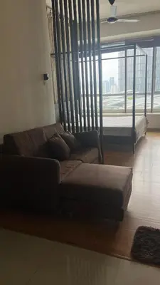 a living room with a couch and a large window at Parkview MALIKA KLCC in Kuala Lumpur