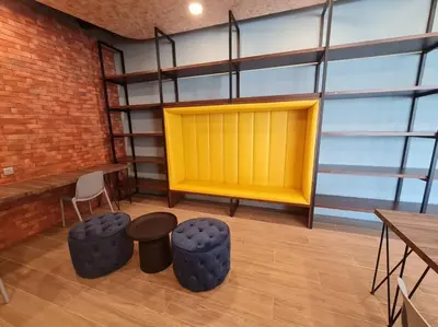a room with a yellow door and some tables and chairs at Tiny Studio Suite Near Gleneagles 10 mins to KLCC in Kuala Lumpur