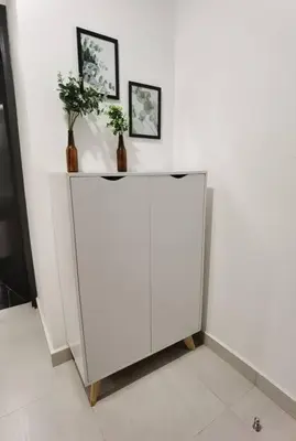a white cabinet with two vases on top of it at Modern Comfy Studio Permaisuri 2 Carpark WIFI in Kuala Lumpur