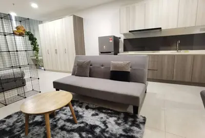 a living room with a couch and a table at Modern Comfy Studio Permaisuri 2 Carpark WIFI in Kuala Lumpur