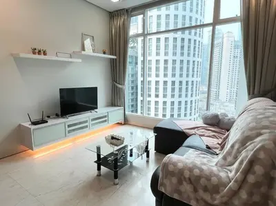 a living room with a couch and a large window at 450m from Aquaria KLCC/KL ConventionCtre, 2 Beds#2 in Kuala Lumpur