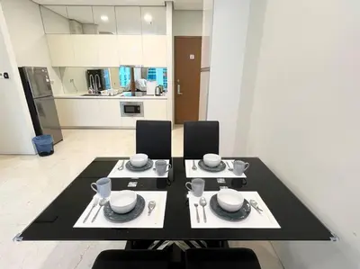 a black table with two chairs and a kitchen at 450m from Aquaria KLCC/KL ConventionCtre, 2 Beds#2 in Kuala Lumpur