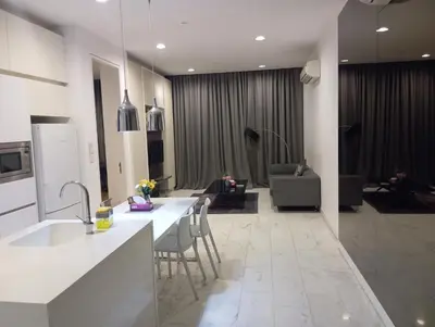 a kitchen with a table and chairs and a living room at Platinum suites klcc by Fifty One in Kuala Lumpur