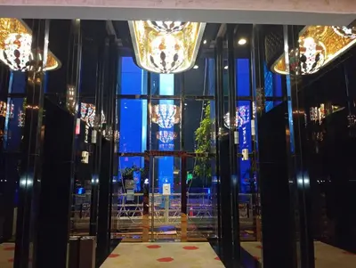 a room with a large window and chandeliers at Platinum suites klcc by Fifty One in Kuala Lumpur