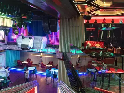 a view of a nightclub with a stage and tables and chairs at Platinum suites klcc by Fifty One in Kuala Lumpur