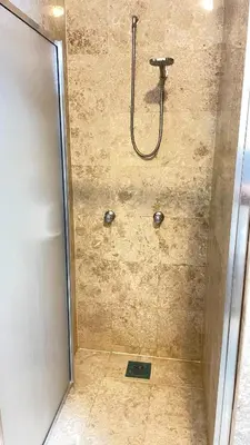 a shower in a bathroom with a glass door at Townhouse in KLCC Vicinity in Kuala Lumpur