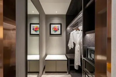 a dressing room with a robe on a mannequin at Imperial Lexis Kuala Lumpur in Kuala Lumpur