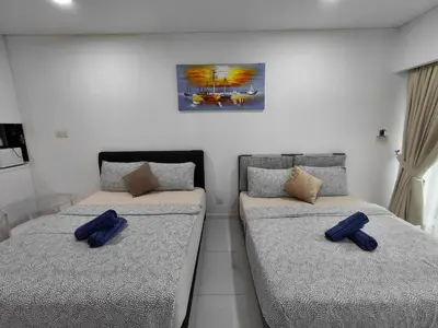 two beds in a room with blue pillows on them at KLCC Summer Suite#3, Monorail, 4Pax in Kuala Lumpur