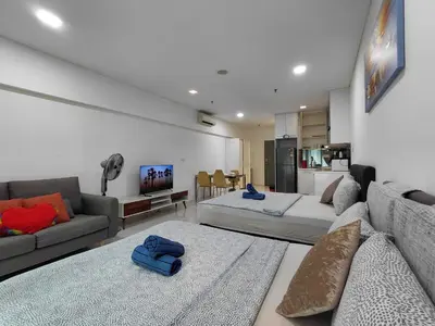 a living room with a couch and a living room with at KLCC Summer Suite#3, Monorail, 4Pax in Kuala Lumpur
