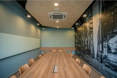 a conference room with a wooden table and chairs at Neu Suite Ampang, LRT Jelatek, Gleneagles Hospital in Kuala Lumpur