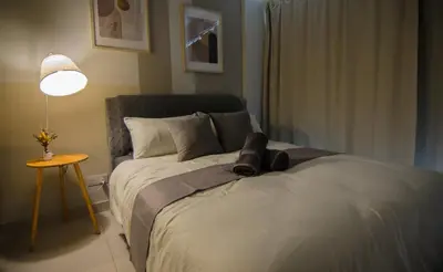 a bedroom with a bed with a pair of shoes on it at KL Dorsett Damas Urban Garden Suite-F-Parking, Self C-In in Kuala Lumpur