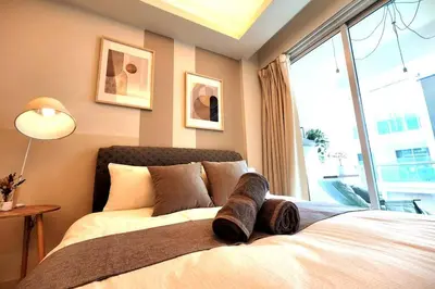 a bedroom with a bed with a large window at KL Dorsett Damas Urban Garden Suite-F-Parking, Self C-In in Kuala Lumpur