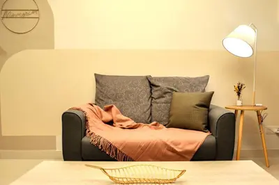 a couch with a blanket on it in a living room at KL Dorsett Damas Urban Garden Suite-F-Parking, Self C-In in Kuala Lumpur