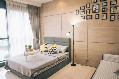 a bedroom with a bed with a lamp and a window at M CITY Near KLCC KPJ Puteri Specialist Hospital in Kuala Lumpur