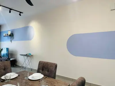 a dining room table with chairs and a white wall at MVC30#Family Suite 8pax 3 Rooms Sunway Velocity Mall Cheras IKEA Mytown Short Walk to MRT & LRT Maluri in Kuala Lumpur