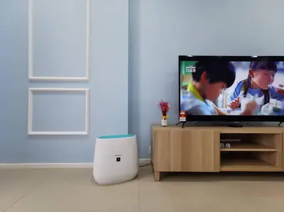 a living room with a flat screen tv on a stand at Arcoris Mont Kiara 15# 163 Sunway Mall # 1 Mont Kiara in Kuala Lumpur