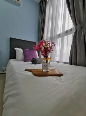 a tray with flowers on a bed with a window at Arcoris Mont Kiara 15# 163 Sunway Mall # 1 Mont Kiara in Kuala Lumpur