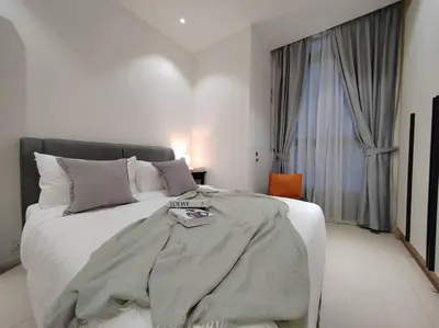 a bedroom with a bed with a blanket on it at Arcoris Mont Kiara 18# Sunway 163 Mall# 1 Mont Kiara # 2 BR with Balcony 2-4 Pax in Kuala Lumpur