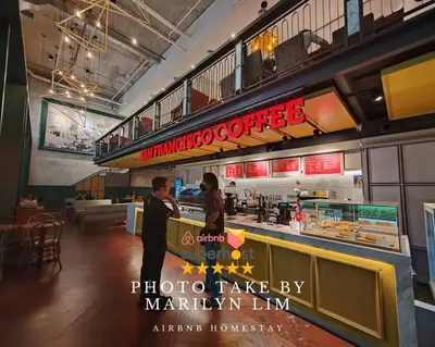 two people standing at a counter in a restaurant at Arcoris Mont Kiara 18# Sunway 163 Mall# 1 Mont Kiara # 2 BR with Balcony 2-4 Pax in Kuala Lumpur