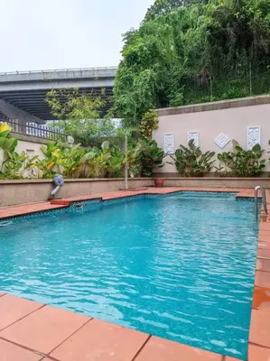 a large blue swimming pool in front of a building at KL Secret Karaoke Private Pool Villa in Ampang