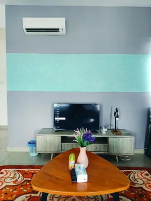 a living room with a table and a tv at Arte Plus by Stay Relax in Kuala Lumpur
