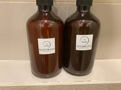 two bottles of sauce sitting on a shelf at Lila House One Bukit Ceylon in Kuala Lumpur