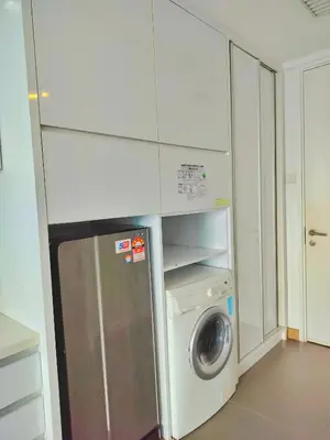 a kitchen with a washing machine and a washer at Lila House One Bukit Ceylon in Kuala Lumpur