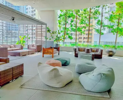 a room with chairs and couches in a building at Lila House One Bukit Ceylon in Kuala Lumpur