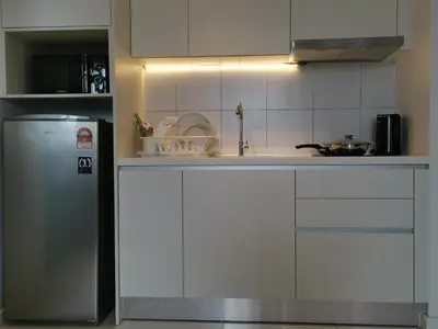 a kitchen with a sink and a refrigerator at Chambers A Studio Flat, KLCC & KL Tower view, City in Kuala Lumpur