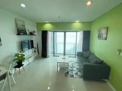 a living room with a couch and a table at Mercu summer suites By Premium Charter in Kuala Lumpur