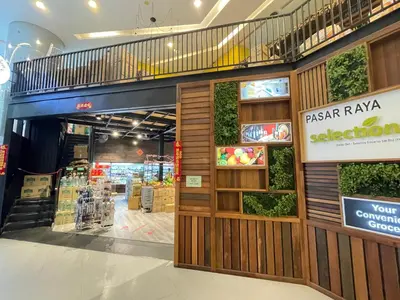 a store front with a wooden door and plants at Mercu summer suites By Premium Charter in Kuala Lumpur