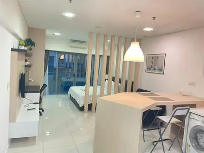a living room with a kitchen and a bedroom at Mercu summer suites By Premium Charter in Kuala Lumpur